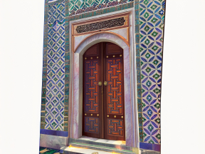 Intricate Geometric Tilework and Arabic Calligraphy on a Historic Islamic Doorway