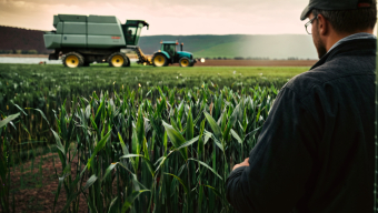 Farmer Inspecting Maize Field with Modern Agricultural Machinery on a Clear Day