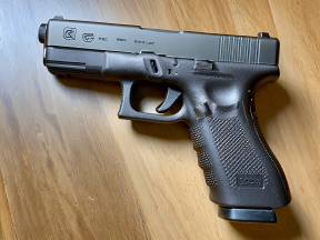 Glock Handgun Displayed Safely on Flat Surface