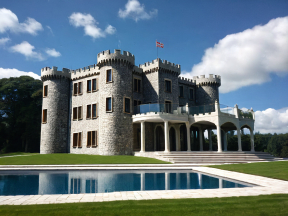 Majestic Medieval-Style Castle Residence with Grand Driveway and Lush Poolside Grounds