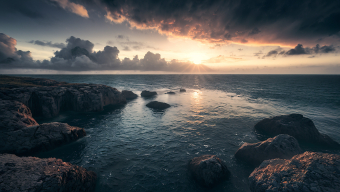 Dramatic Coastal Sunrise: Moody Skies and Choppy Waves at the Rocky Shoreline