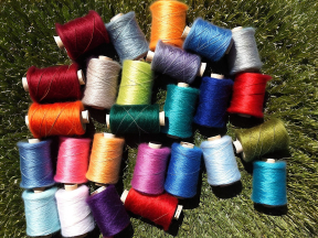 Colorful Skeins of Yarn Displayed Outdoors on a Textured Surface