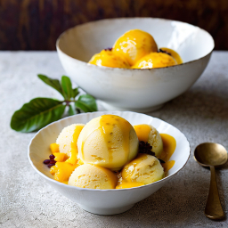 Delicious Vanilla Ice Cream with Golden Sauce in White Bowls Amidst Natural Greenery