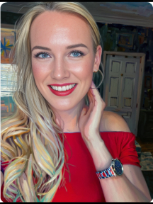 Confident Blonde Woman in Red Top Posing Indoors with Artwork Background