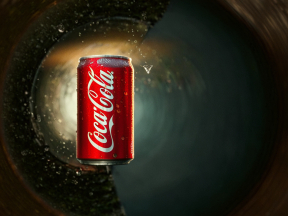 Submerged Refreshment: A Carbonated Coca-Cola Can Sinking Beneath the Surface