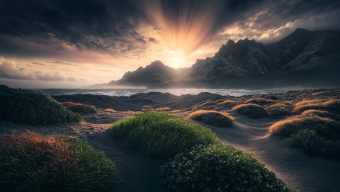 Sunset Serenity: A Dramatic Coastal Landscape of Rugged Rocks and Glowing Skies