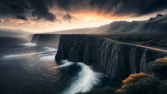 Sunset Over Rugged Cliffs: A Majestic Ocean View from the Mountain Road