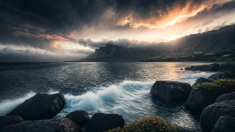 Dramatic Coastal Landscape at Sunrise with Stormy Seas and Mountain Silhouettes