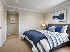 Modern and Serene Bedroom with Landscape Artwork and Dark Bedding