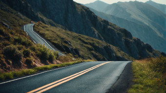 Serene Mountain Valley: A Winding Road Through Majestic Peaks