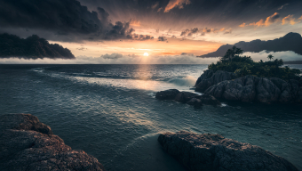 Stormy Coastal Dawn: Turbulent Waves and Rugged Cliffs at Sunrise