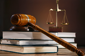 Symbols of Justice: A Judge's Bench Featuring the Gavel, Law Books, and Scales of Justice in a Courtroom Setting