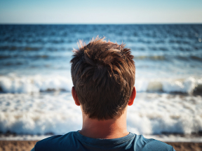 Solitude by the Shore: A Serene Moment Watching Ocean Waves