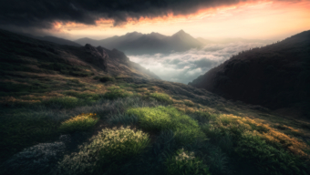 Golden Sunrise Over Rugged Mountain Landscape: A Majestic Natural Scene